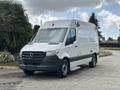 A 2020 Mercedes-Benz Sprinter 2500 van in white with a high roof and large front grille parked on a driveway