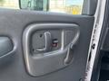 Interior door handle of a 2007 GMC C4500 TopKick showing the locking mechanism and a manual window crank
