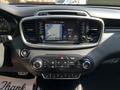 The dashboard of a 2017 Kia Sorento featuring a touchscreen display with navigation and radio controls along with climate control buttons