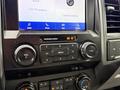 The interior dashboard of a 2020 Ford F-550 featuring a control panel with audio and media buttons along with a digital display screen