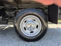 Close-up of a wheel and tire of a 2012 Ford F-350 SD featuring a silver alloy rim and a black Bridgestone tire