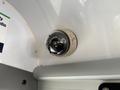 A ceiling-mounted surveillance camera inside a vehicle with a round dome shape and a white base