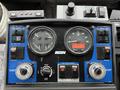 Control panel of a 2009 UD Trucks UD 3300 featuring gauges for RPM and engine speed along with various operational buttons and switches
