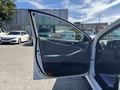 A 2015 Hyundai Sonata with an open front door showing the interior features and seat upholstery