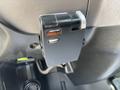A close-up of a black CURT Discovery brake controller mounted on the dashboard of a 2020 Peterbilt 330