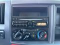Dashboard of a 2012 Isuzu NPR HD featuring a radio and climate control knobs