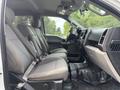 A 2017 Ford F-150 interior showing front seats and dashboard with a modern design and fabric upholstery