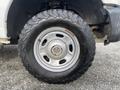 A close-up of a wheel and tire from a 2015 Ford F-250 SD showcasing a rugged design and tread pattern