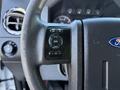 Close-up of the steering wheel of a 2010 Ford F-450 featuring controls for settings and information on the left side