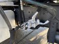A close-up of the hydraulic system on a 2015 Hino 358 featuring various metallic components and hoses connected to a valve assembly