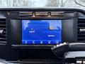 Dashboard display of a 2023 Ford F-250 with a touchscreen interface showing options for audio control and phone connectivity