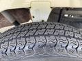Close-up of a tire from a 2010 Daihatsu Hijet showcasing its tread pattern and texture