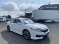 A 2017 Honda Accord Hybrid in white with sleek lines and modern design features, showcasing its hybrid badge and stylish alloy wheels