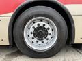 Close-up view of the wheel of a 2016 Grande West Vicinity bus showing the tire tread and the metal rim with multiple lug nuts