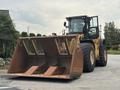 A yellow and black 2012 Caterpillar 980 wheel loader with a large front bucket, equipped for heavy lifting and construction tasks