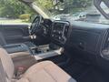 Interior of a 2017 Chevrolet Silverado 1500 featuring a black dashboard a center console and cloth seating