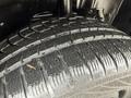 Close-up of a wet tire on a 2019 Ford Explorer showcasing its tread pattern and rubber texture