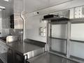 Interior of a 2020 Freightliner MT45 food truck featuring stainless steel counters a sink and electrical outlets