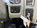 Dashboard controls of a 2011 International 4300 truck featuring buttons for park and regen functions along with a key in the ignition