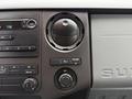 Dashboard controls of a 2015 Ford F-350 SD including audio system knobs and air conditioning settings
