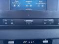 The interior dashboard of a 2024 Mercedes-Benz Sprinter 2500 featuring a touchscreen display and control buttons for navigation and audio settings