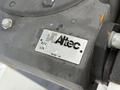 A metal identification plate attached to a 2015 Freightliner M2 showing the Altec logo part number and serial number details