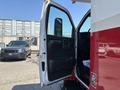 A 2007 GMC C4500 TopKick with an open driver's side door revealing the interior controls and seating area