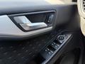 The image features the interior door panel of a 2020 Ford Escape with controls for windows and locks along with a silver door handle