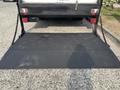 A 2008 Ford Econoline with a black loading ramp in the foreground