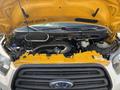 A 2018 Ford Transit-350 with its hood raised revealing the engine compartment featuring various components and hoses