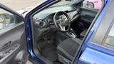 Interior view of a 2019 Nissan Kicks showing the driver's seat steering wheel dashboard and gear shift with black upholstery and a modern design