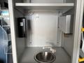 A stainless steel sink with a faucet mounted inside a storage compartment of a 2020 Mercedes-Benz Sprinter 2500