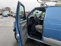 A blue 2006 Ford Econoline van with an open front door showcasing the driver's seat and dashboard inside