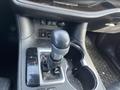 The center console of a 2018 Toyota Highlander featuring the gear shift lever with P R N D S markings and storage compartments