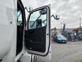 A 2025 Peterbilt 536 truck with the driver's door open showcasing the interior door panel and handle