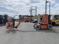 A 2009 JLG E300AJP articulated boom lift with a wheeled base and an extended platform for elevating workers and equipment