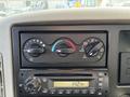 Dashboard controls of a 2012 International DuraStar 4300 featuring climate control knobs and a radio display showing the time
