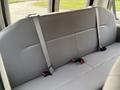 A gray fabric bench seat with three seat belts in a 2013 Ford E-350 Super Duty