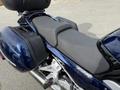 A blue 2016 Yamaha FJR1300AE motorcycle featuring a dual seat and side bags with a sleek design and a sporty look