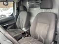 Two front seats of a 2017 Ford Transit Connect with a gray fabric design and armrest in between