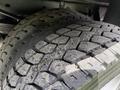 Close-up of a set of rugged tires on a 2008 Ford F-550 showcasing deep tread patterns and a slightly worn surface indicating use on various terrains
