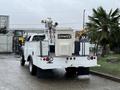 A white 2012 Ford F-450 SD truck with a utility bed featuring a bucket lift and tool storage mounted on the back