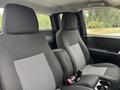 Interior view of a 2011 Chevrolet Colorado showing two black fabric front seats with gray patterned inserts and a center console between them