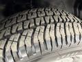 Close-up of the tread on a tire from a 2004 Chevrolet Express showcasing deep grooves and textures for traction