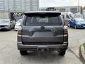 A gray 2021 Toyota 4Runner viewed from the back with the rear lights visible and the vehicle's emblem centered on the hatch