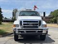A white 2015 Ford F-750 truck with a large front grille and two side mirrors facing forward