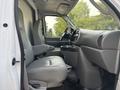 Interior of a 2008 Ford Econoline showing two grey front seats and a dashboard with steering wheel and console