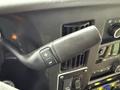 Close-up of a gear shift lever in a 2019 Chevrolet Express with buttons for adjusting gears and control features