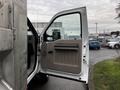 A 2009 Ford F-550 with its driver's side door open showing the interior panel and seating area