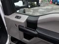 Interior door panel of a 2018 Ford F-550 featuring a handle power window controls and storage pocket